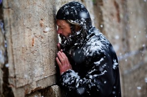 Snow falls a an ultra-orthodox Jewish man prays at the Western Wall in Jerusalem's Old City, Thursday, Jan. 10, 2013. Stormy weather conditions continued on Thursday with snow, torrential rains and strong winds across the region. (AP Photo/Bernat Armangue)